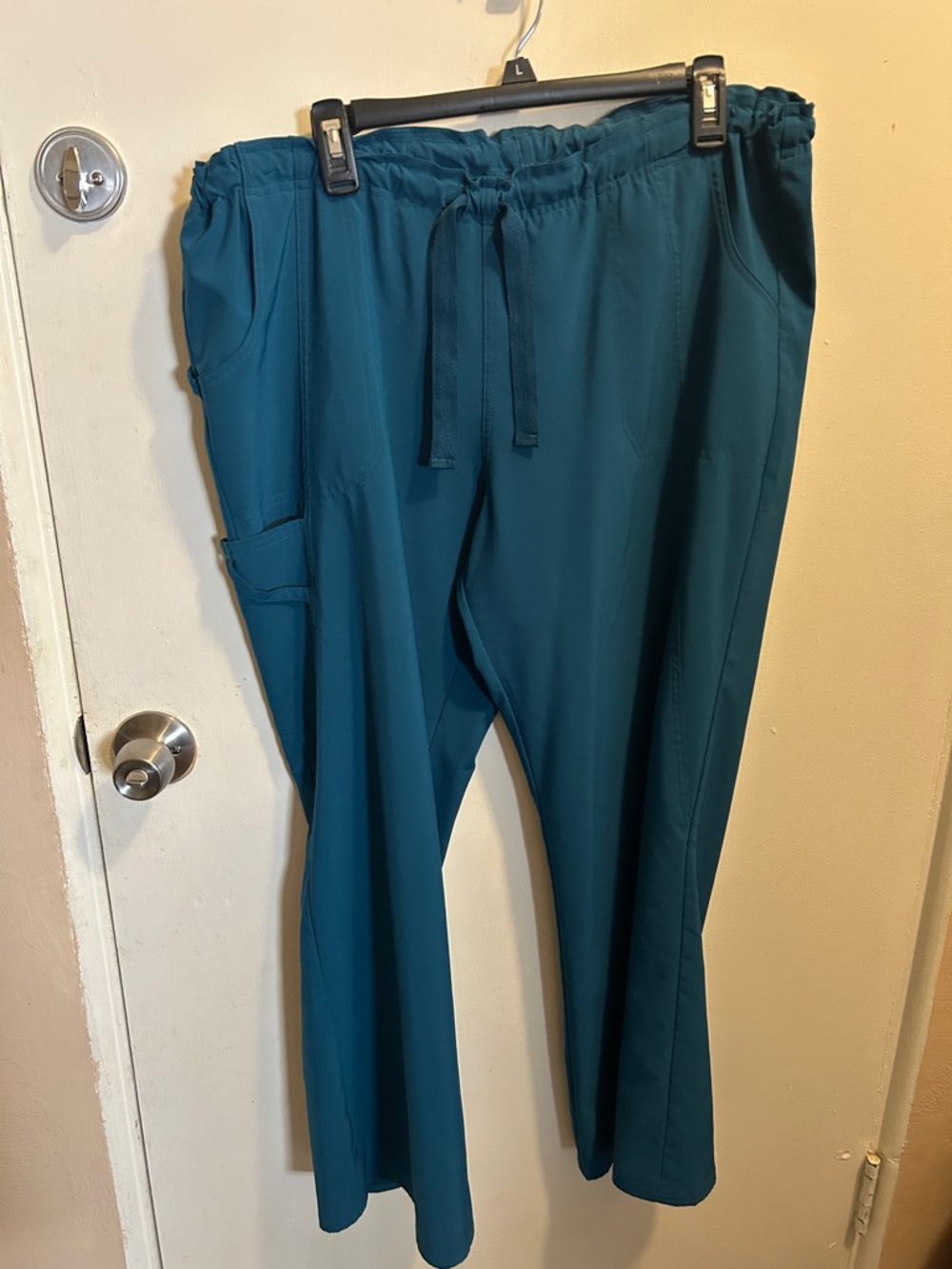 Teal slacks, nice poly material for extra comfort. Several pockets.